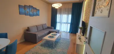 a living room with a couch and a table at Apartment Sofia, City Centar in Podgorica