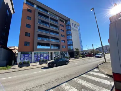 a car parked in front of a building on a street at Apartment Sofia, City Centar in Podgorica