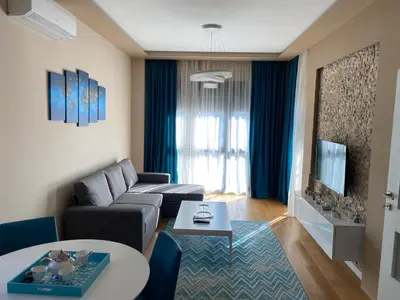 a living room with a couch and a table at Apartment Sofia, City Centar in Podgorica
