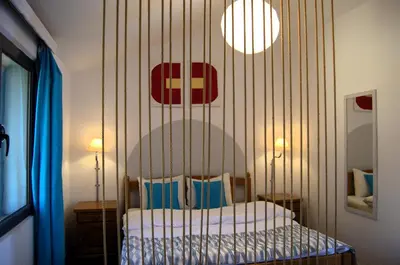 a bedroom with a bed with a striped wall at Yeshill Apart & Studio in Budva