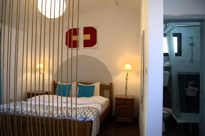 a small bedroom with a bed and a mirror at Yeshill Apart & Studio in Budva