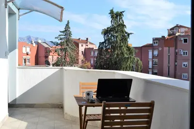 a laptop computer sitting on a table on a balcony at Yeshill Apart & Studio in Budva