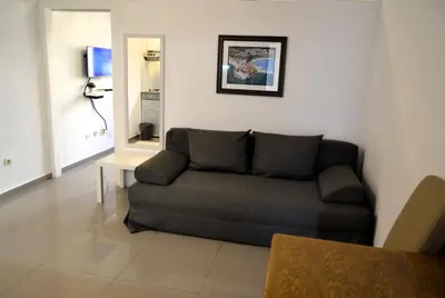 a living room with a couch and a table at Yeshill Apart & Studio in Budva