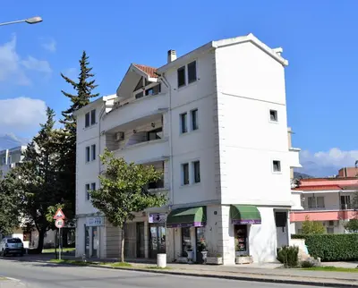 a white building on the side of a street at Yeshill Apart & Studio in Budva