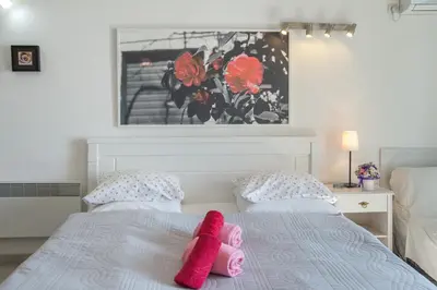a bedroom with two pink towels on a bed at Apartments Inspiration in Budva