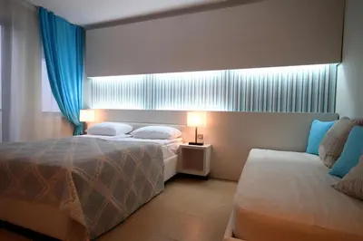 a hotel room with two beds and a window at Domador Rooms & Apartments in Budva