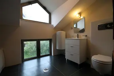 a bathroom with a toilet and a sink and a window at Domador Rooms & Apartments in Budva