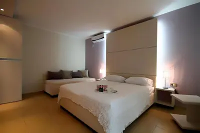 a hotel room with a bed and a couch at Domador Rooms & Apartments in Budva