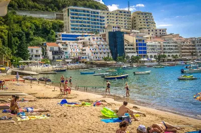 a group of people on a beach in a city at Domador Rooms & Apartments in Budva