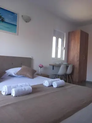 a bedroom with a bed with two towels on it at Vila Nina Donji Štoj in Ulcinj