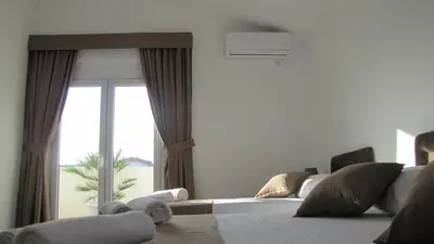 a bedroom with a bed and a large window at Vila Nina Donji Štoj in Ulcinj