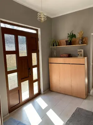 a room with a door and a counter with a plant at Glass house in Ulcinj