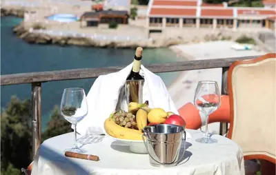 a table with a bowl of fruit and a bottle of wine at Awesome Apartment In Utjeha With Wifi in Utjeha