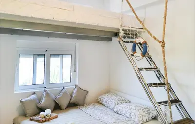 a hanging bed in a room with pillows and a ladder at Awesome Apartment In Utjeha With Wifi in Utjeha