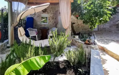 a garden with a pond in the middle at Awesome Apartment In Utjeha With Wifi in Utjeha