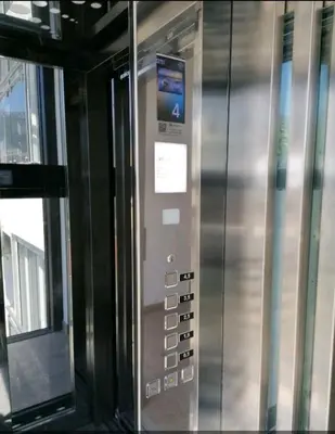 a metal elevator with a sign on the side of it at Vi studio city center 2min to sea in Bar