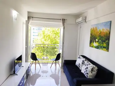 a living room with a couch and a table and a window at Vi studio city center 2min to sea in Bar