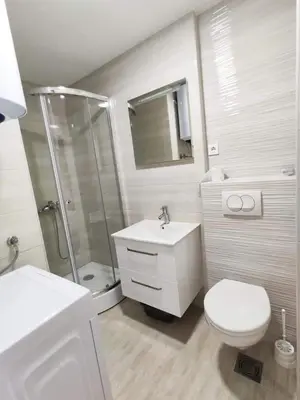 a bathroom with a toilet sink and a shower at Vi studio city center 2min to sea in Bar