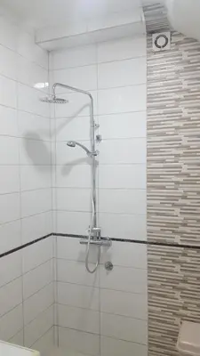 a shower with a glass door in a bathroom at Apartments F in Podgorica