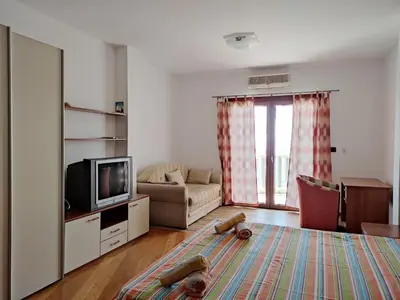 a living room with a tv and a couch at Apartments Altea in Rafailovici