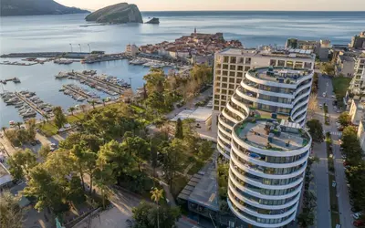 an aerial view of a large building next to a harbor at Amare Luxury Apartments in Budva