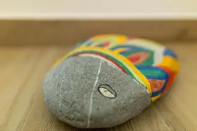 a rock with a rainbow on it sitting on a table at Amare Luxury Apartments in Budva