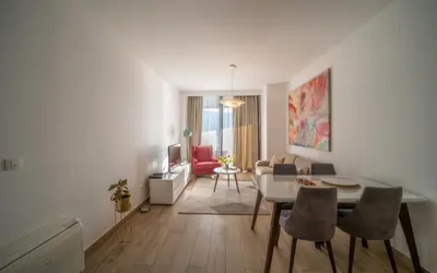a living room with a table and chairs at Amare Luxury Apartments in Budva