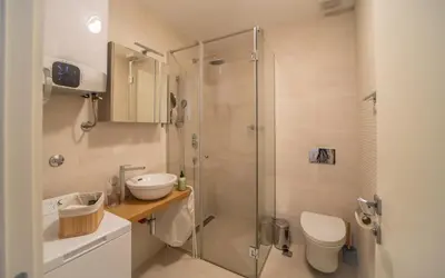 a bathroom with a shower with a toilet and a sink at Amare Luxury Apartments in Budva