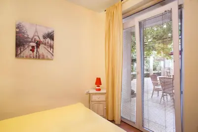 a bedroom with a bed and a sliding glass door at Splendid Apartments in Budva