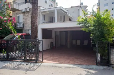 a garage with a gate in front of a house at Splendid Apartments in Budva