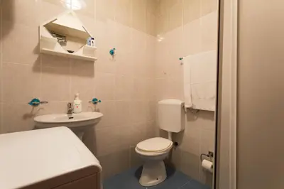 a small bathroom with a toilet and a sink at Splendid Apartments in Budva