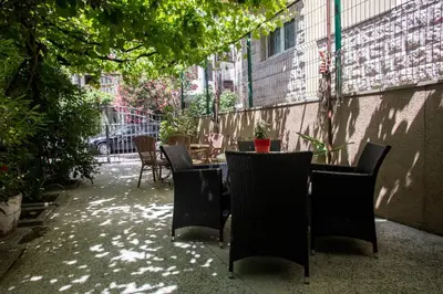 a patio with chairs and a table in a courtyard at Splendid Apartments in Budva