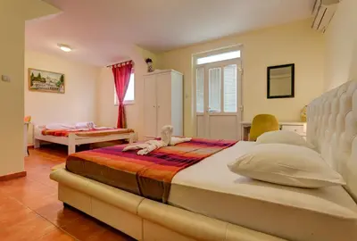 a bedroom with a bed with a doll on it at Splendid Apartments in Budva