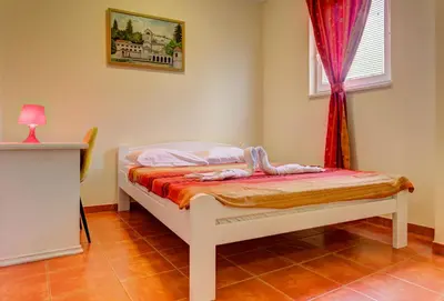 a small bed in a room with a window at Splendid Apartments in Budva