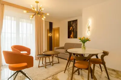 a living room with a table and chairs and a couch at Apartmani Enydoo in Ulcinj