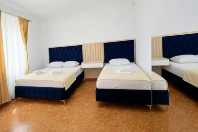 a hotel room with two beds in a room at Apartmani Enydoo in Ulcinj