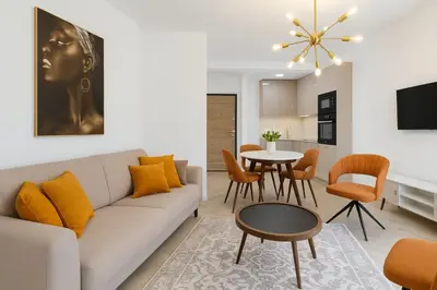 a living room with a couch and a table at Apartmani Enydoo in Ulcinj
