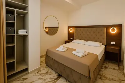 a bedroom with a bed with two towels on it at Apartmani Enydoo in Ulcinj