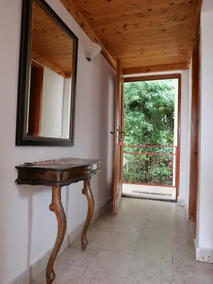 a table in a room with a mirror and a window at Apartments Almaja Villa in Petrovac na Moru