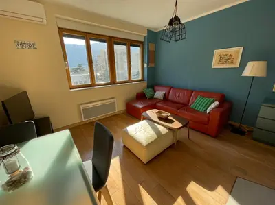 a living room with a red couch and a table at Downtown Apartment in Kotor
