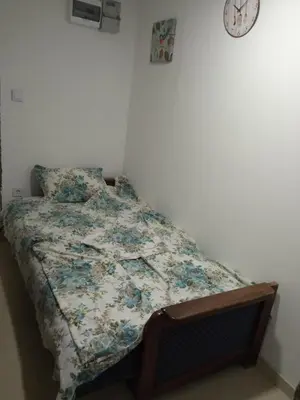 a bed with a quilt on it in a bedroom at Monte room in Podgorica