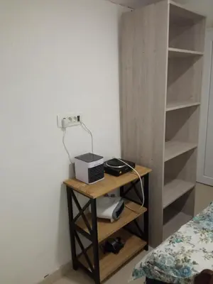 a room with a table with a radio and a bed at Monte room in Podgorica