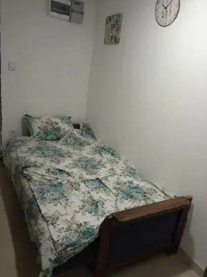 a bed with a quilt on it in a bedroom at Monte room in Podgorica