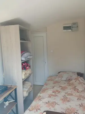 a bedroom with a bed and a book shelf at Monte room in Podgorica