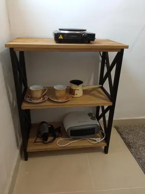 a wooden shelf with two cups and a printer at Monte room in Podgorica