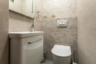 a small bathroom with a toilet and a sink at Villa Una in Kotor