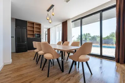 a dining room with a wooden table and chairs at Villa Una in Kotor