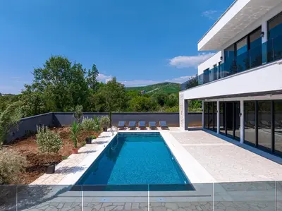 a swimming pool in the backyard of a house at Villa Una in Kotor