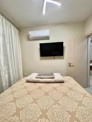 a bedroom with a bed and a flat screen tv at Nevenka in Bar