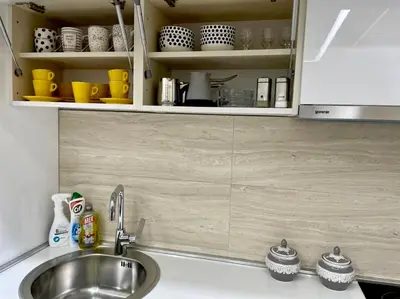 a kitchen counter with a sink and a cupboard at Nevenka in Bar